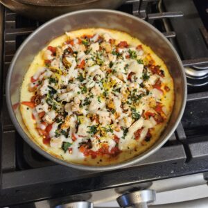 healthy cottage cheese pizza bowl with roasted garlic chicken and melted mozzarella