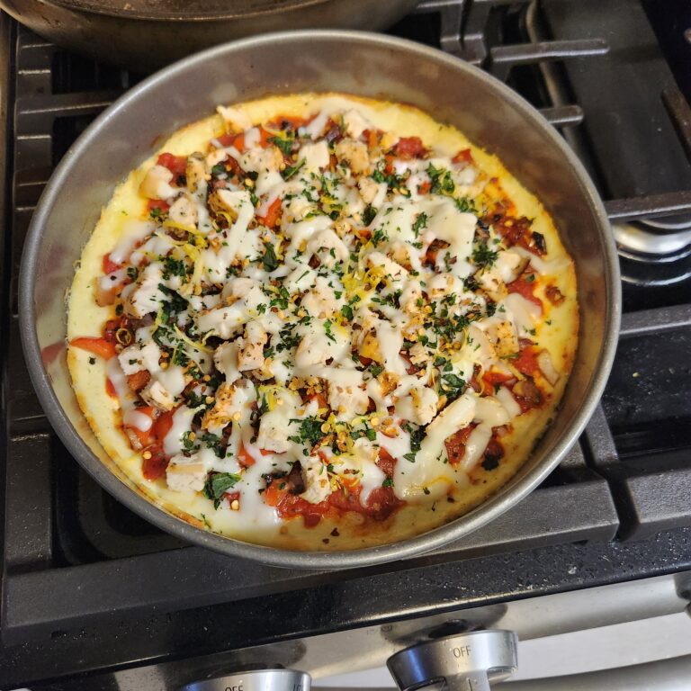 healthy cottage cheese pizza bowl with roasted garlic chicken and melted mozzarella